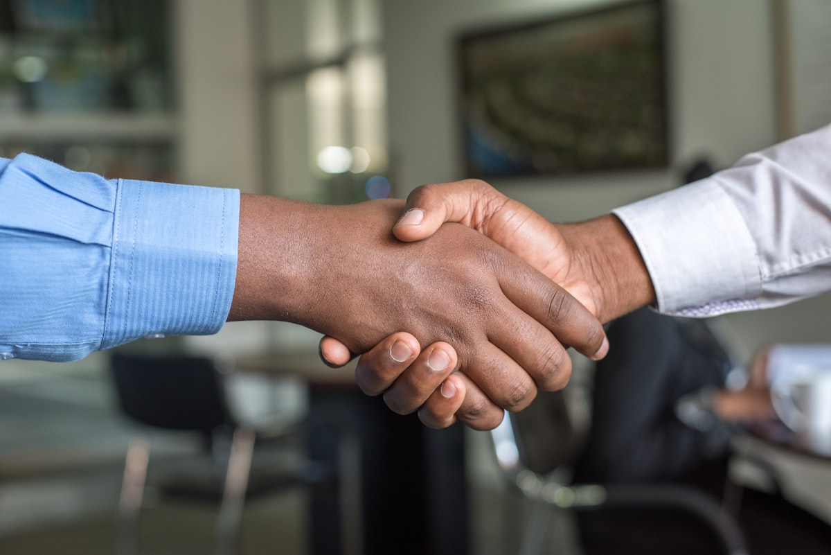 Two people shaking hands on a finalised agreement